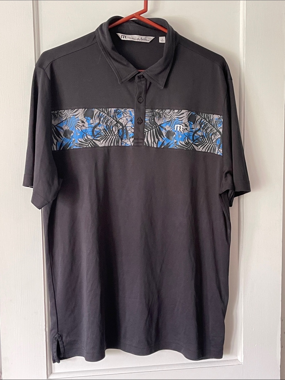 Travis Mathew Black Polo with Blue Tropical Chest Band